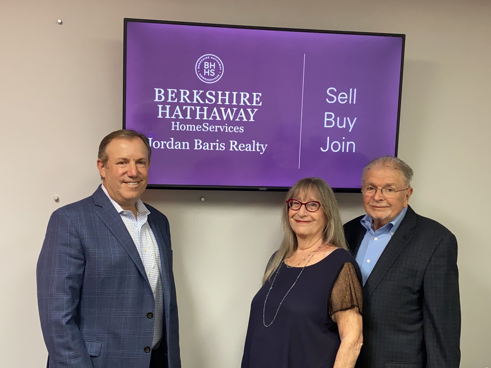 Ken Baris with Drs. Teri and Michael Gamble at BHHS Jordan Baris Realty, welcoming the Gold Star team